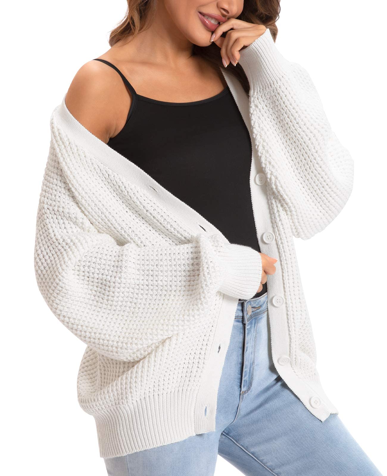 Model wearing the chunky off-white cardigan slightly off-shoulder for a trendy, casual autumn look
