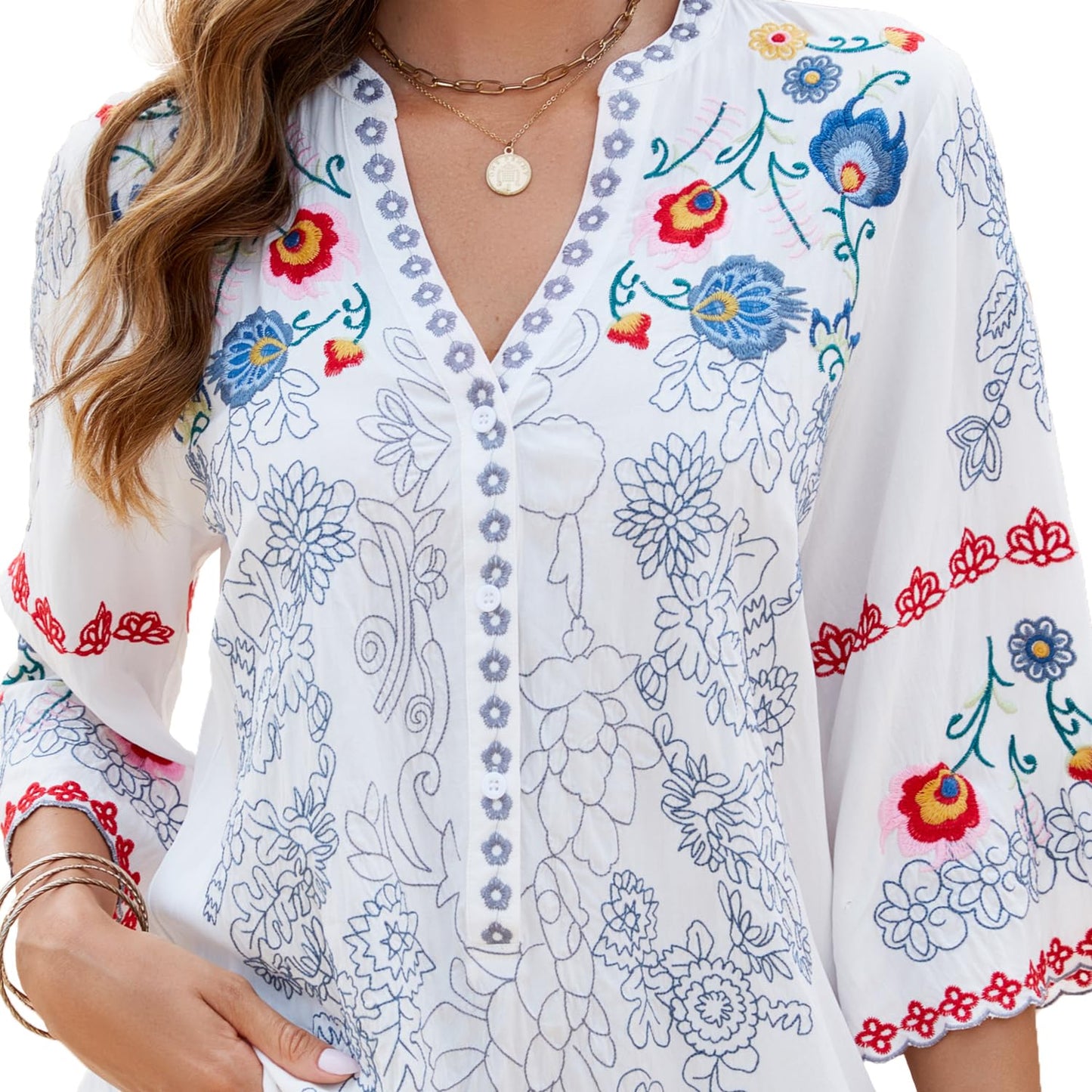 Close-up detail of the artisan blue and red floral embroidery and front button-up closure of the GORGLITTER peasant blouse.