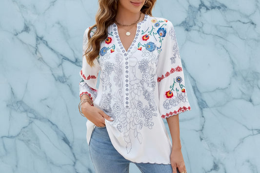 GORGLITTER women's white boho peasant blouse featuring blue and red floral embroidery and a button-down V-neckline.