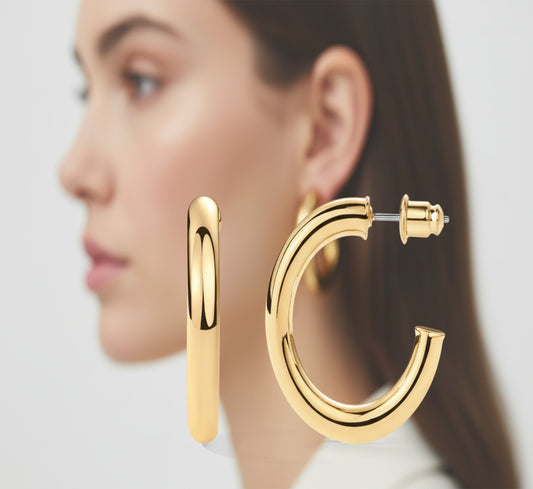 Front and side views of the PAVOI 14K Gold Vermeil Chunky Hoop Earrings, featuring a thickness of 4.5mm and a luxurious glossy finish, with a profile view of a woman wearing the earrings in the background.